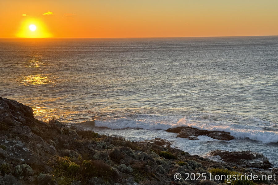 Waves Crash on the Rocks Near Sunset